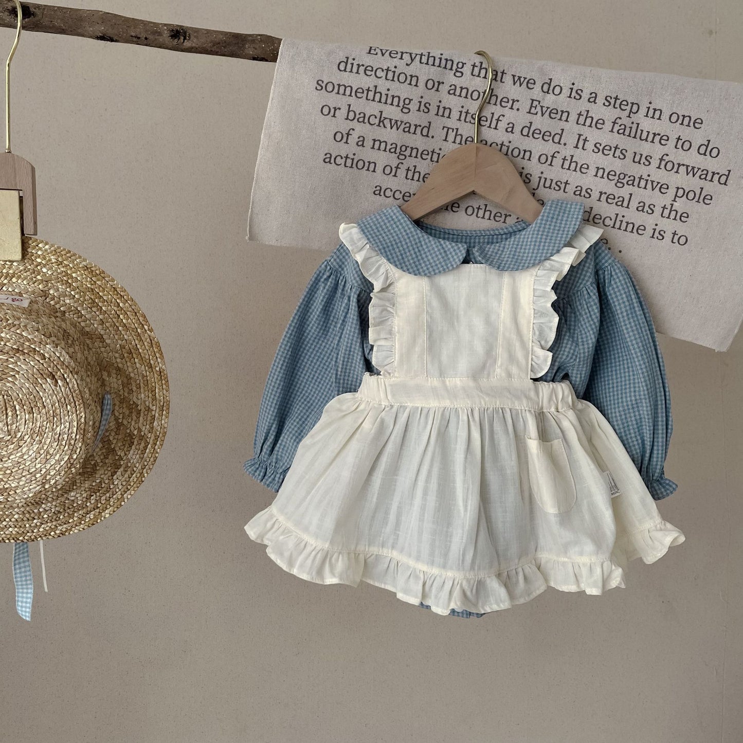 Baby-Strampler mit einreihiger Knopfleiste, langen Ärmeln, kleinem Karomuster, kleinem Überrock und Tragetuch
