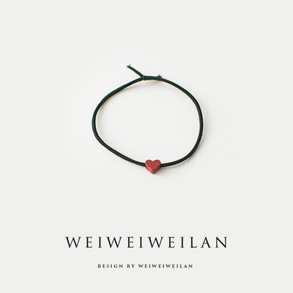 Einfaches, vielseitig kombinierbares Haargummi mit farbigem Herzmotiv