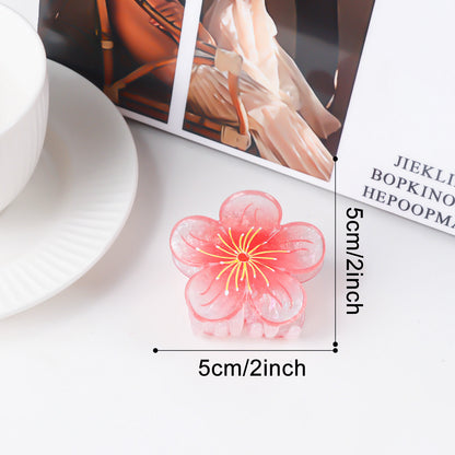 Süße Pflaumenblüten-Feenfrisur im floralen Hochsteckfrisur-Stil mit Haifisch-Haarspange – passend für alle Damen.