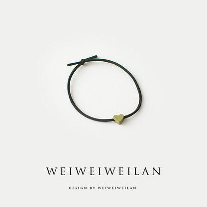 Einfaches, vielseitig kombinierbares Haargummi mit farbigem Herzmotiv