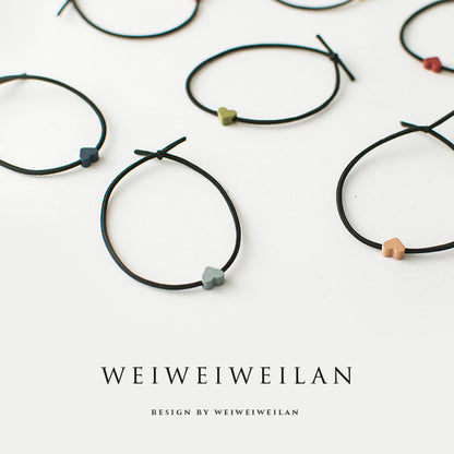 Einfaches, vielseitig kombinierbares Haargummi mit farbigem Herzmotiv