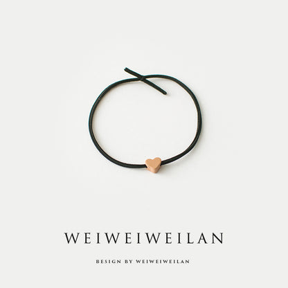 Einfaches, vielseitig kombinierbares Haargummi mit farbigem Herzmotiv